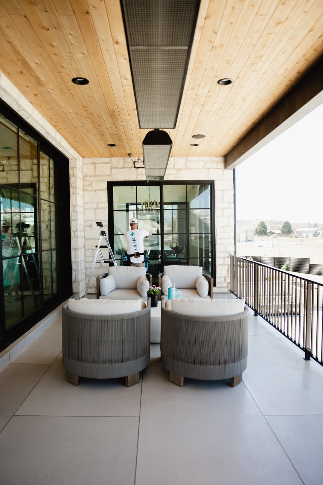 Stylish outdoor seating area with modern furniture and panoramic windows.