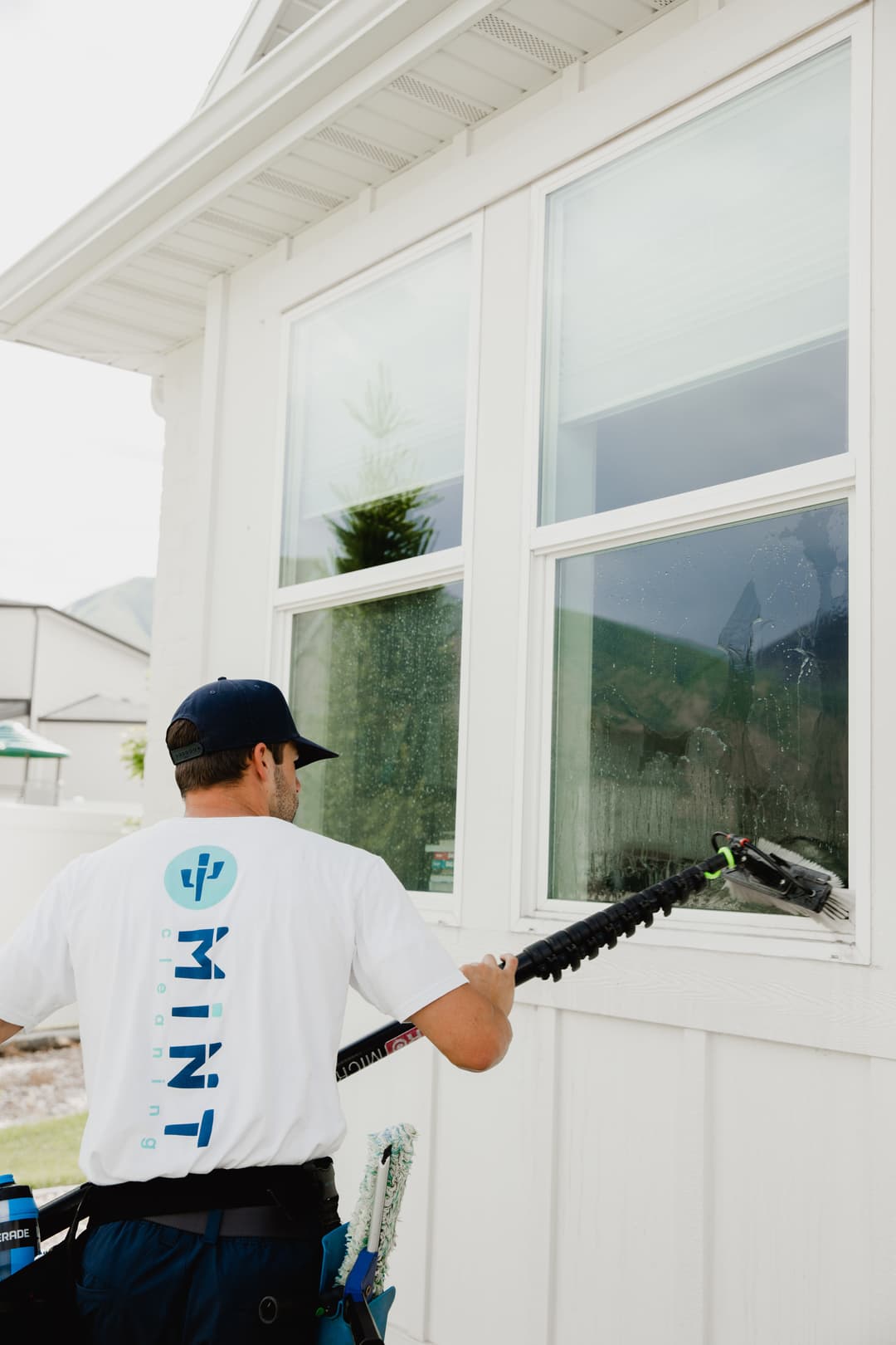 Window cleaning service in action, featuring a technician using specialized equipment.